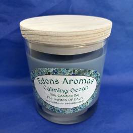 Calming Ocean scented soy candle in a glass jar with a wooden lid