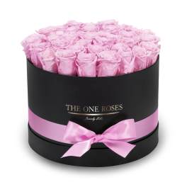 Round box filled with pink roses and tied with a pink ribbon