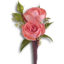 Pink rose boutonniere with green buds and ribbon-wrapped stem