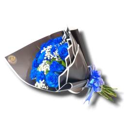 Bouquet of blue roses with white filler flowers wrapped in dark paper