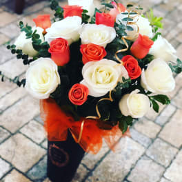 Bouquet of red and white roses with ribbon in a black wrap