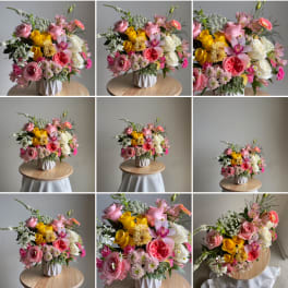 Colorful mixed bouquet in a white vase on a round table