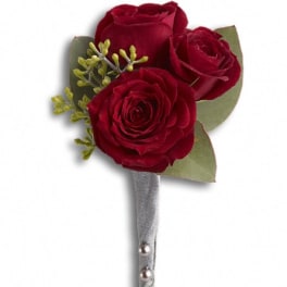 Three red rose boutonniere with silver ribbon and pearl pins