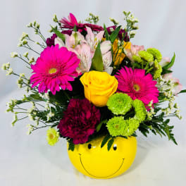 Mixed bouquet in a yellow smiley-face container