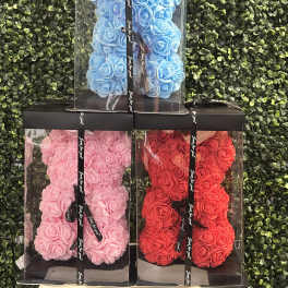 Three boxed rose teddy bears in blue, pink, and red