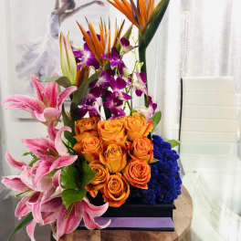 Tall tropical bouquet with orange roses, pink lilies, and purple orchids