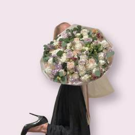 Beautiful and large bouquet of different flowers with the addition of greenery.