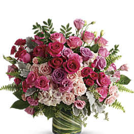 Pink and lavender rose bouquet in a glass vase