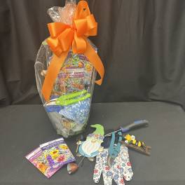 Garden gift set with seed packets, gloves, and tools tied with an orange bow