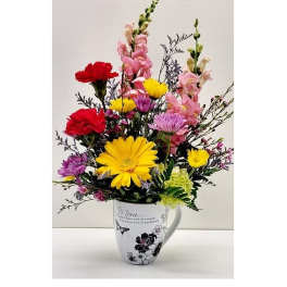 Colorful mixed bouquet in a white mug vase