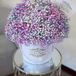 Large pastel bouquet of tiny pink, purple, blue, and white flowers in a white box