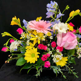 Mixed bouquet with pink rose, gerbera daisy, and yellow blooms