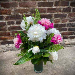 Bouquet of white and pink flowers in a green vase