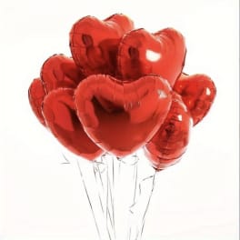 Cluster of red heart-shaped balloons on strings