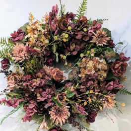 Large bouquet of muted pink and burgundy flowers with greenery