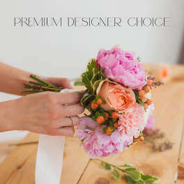 Pink and peach bridal bouquet with a white ribbon