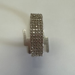 Small silver rhinestone earring on a plain background