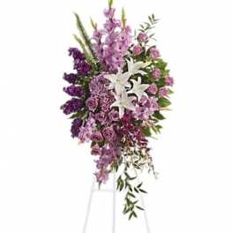Tall purple and white floral standing spray on a metal easel