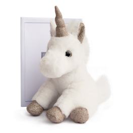 Plush white unicorn with glittery gold horn and hooves sitting in front of a box