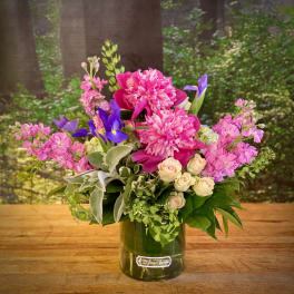 Pink and purple mixed bouquet in a glass vase