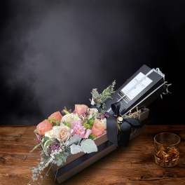 Boxed bouquet of pastel roses and mixed flowers with a ribbon