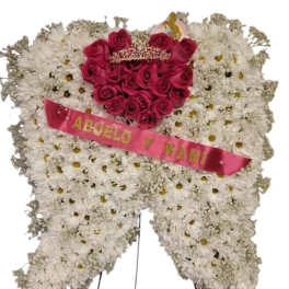 Heart-shaped floral wreath with pink roses and a pink ribbon