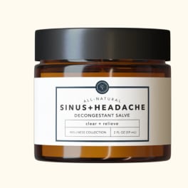Amber glass jar of sinus and headache decongestant salve with white label and black lid