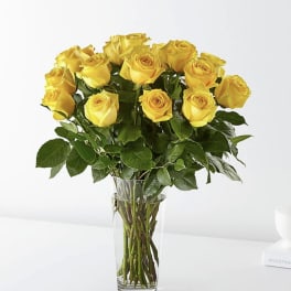 Yellow roses arranged in a clear glass vase