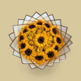 Bouquet of yellow sunflowers and roses wrapped in layered paper