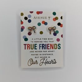 A greeting card with colorful bow-shaped earrings attached.