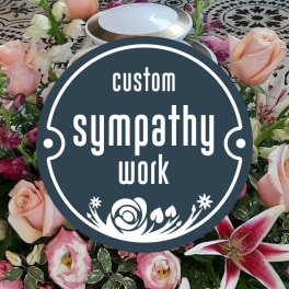 Sympathy floral arrangement with pink roses and lilies