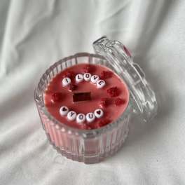 Pink candle in a clear glass jar with a lid and "I LOVE YOU" beads