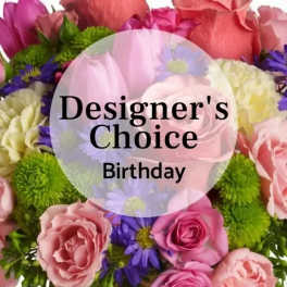 Mixed pink and purple flowers with a birthday label