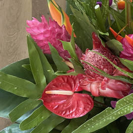 Wrapped floral bouquet wrapped in floral paper and a bow