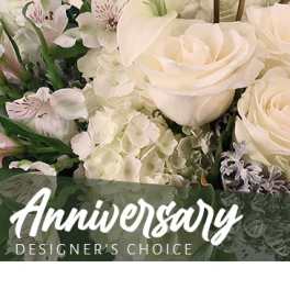 White roses and lilies with hydrangeas in a floral arrangement