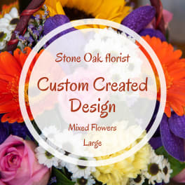Mixed bouquet with orange, purple, pink, and white flowers