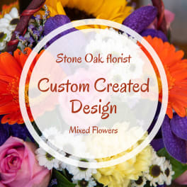 Mixed bouquet with orange, purple, pink, and white flowers