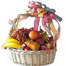 Wicker gift basket filled with assorted fresh fruit and topped with multicolored ribbons.