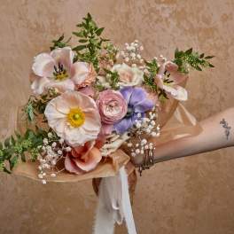 Hand-tied bouquet of pastel flowers with ribbon wrap