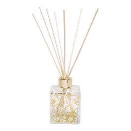 Decorative reed diffuser in a clear floral glass bottle