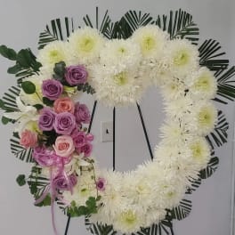 Heart-shaped floral wreath with white chrysanthemums and pink-purple roses