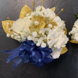 Two small white floral bouquets with gold accents and ribbon bows