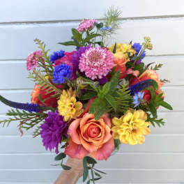 Colorful bouquet with roses, dahlias, and blue accent flowers