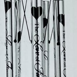 Black metal wind chime with engraved tubes and a LOVE pendant