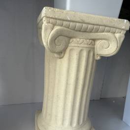 Beige decorative pedestal column with a fluted shaft and ornate top