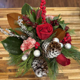 Holiday bouquet with red roses, carnations, pinecones, and ornaments