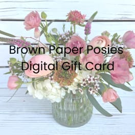 Pink and white mixed flower arrangement in a glass vase