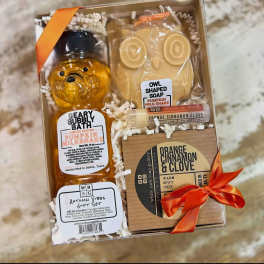 Autumn-themed gift set with soap, lip balm, and candle in a box