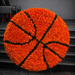 Large orange floral basketball display on a stand