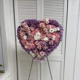 Heart-shaped floral standing spray in pink, white, and purple